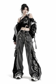 Woman in a black crop top and cargo pants with chains and dragon embroidery