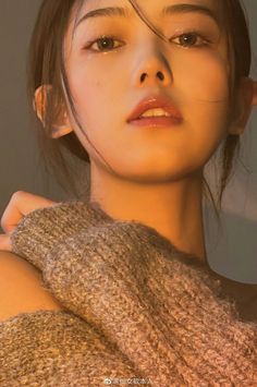 Close up portrait of a woman in a knitted sweater with warm lighting