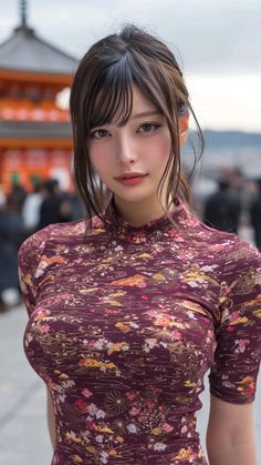 Woman with long hair in a floral print top outdoors