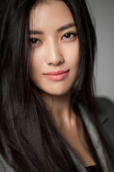 Woman with long black hair in a portrait shot with soft lighting