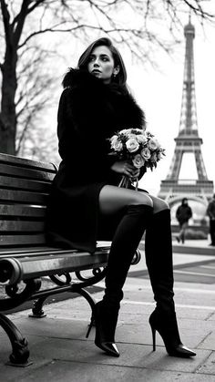 Woman in a fur coat and thigh-high boots sitting on a bench with the Eiffel Tower in the background