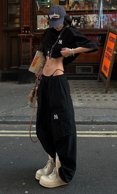 Person in a crop top and cargo pants on a street
