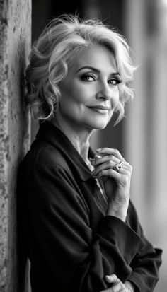 Black and white portrait of a woman with curly short hair and a ring