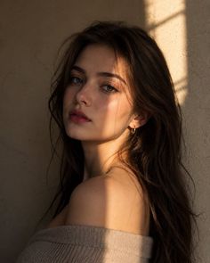 Woman with long hair in an off-shoulder sweater with golden hour lighting