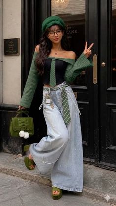 Woman in a green beret and off-shoulder top posing on a street