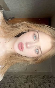 Close up portrait of a woman with long blonde hair and blue eyes