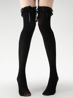 Legs wearing black thigh-high socks with ruffle trim and bows