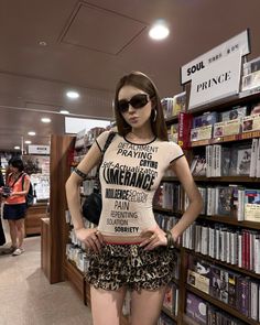 Woman in a leopard print skirt and sunglasses posing in a music store