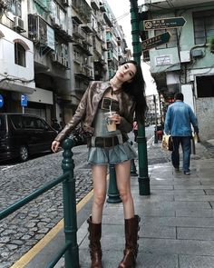 Woman in a leather jacket and mini skirt on a city street