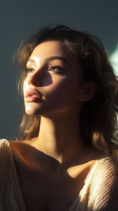 Woman with long hair in dramatic golden hour lighting, looking upwards