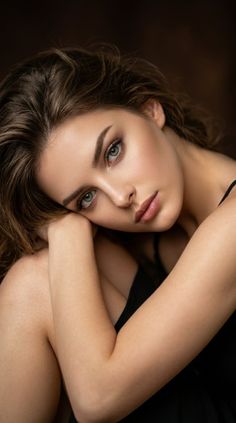 Woman with long hair and green eyes in a close-up portrait with soft lighting
