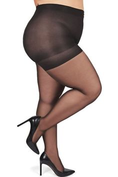 Woman in black tights and high heels posing against a white background