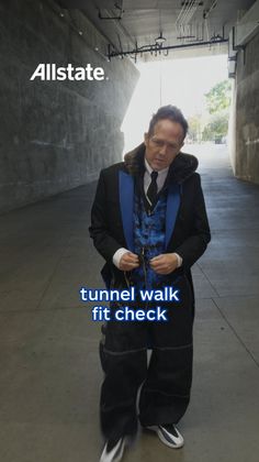Man in a suit jacket and wide leg pants in a tunnel