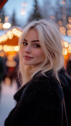 Blonde woman in a fur coat at night with bokeh lights in the background