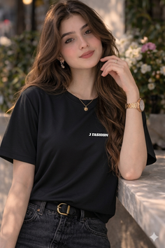Woman with long brown hair wearing a black t-shirt and jeans outdoors