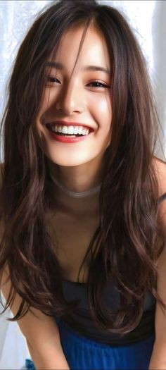 Woman with long dark hair and a choker, smiling brightly