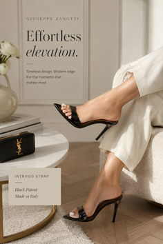Woman's legs in black high heels and white pants, sitting indoors
