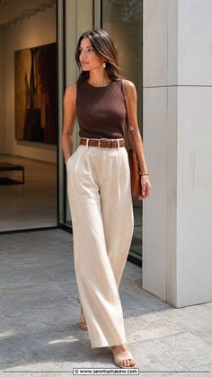 Woman in a brown tank top and wide leg pants with a braided belt outdoors