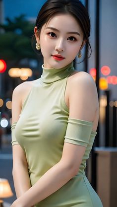 Woman in a light green sleeveless top with a high neck and earrings