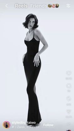 Woman in a black dress with short wavy hair posing in a studio