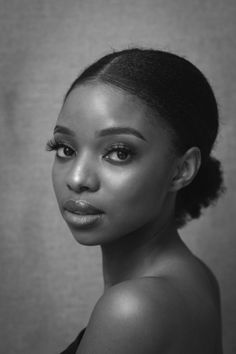 Woman with an updo hairstyle and bare shoulders in a black and white portrait
