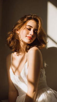 Woman with short hair and freckles in a white dress with soft lighting