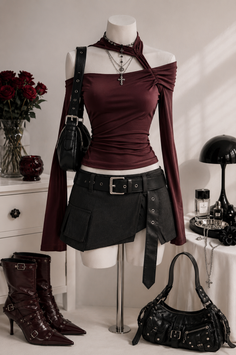 Mannequin dressed in a burgundy top and black mini skirt with gothic accessories