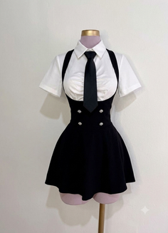School uniform with a white shirt, black tie, and black dress on a mannequin