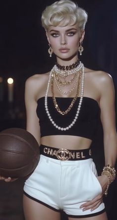 Woman with blonde short hair wearing a tube top and white shorts, holding a basketball