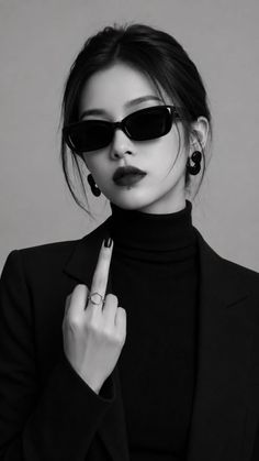 Woman in sunglasses and a turtleneck showing her middle finger