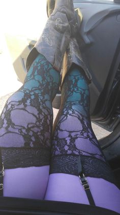 Person wearing cowboy boots, lace stockings, and a garter belt in a car