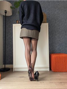 Person in black stockings and high heels from behind