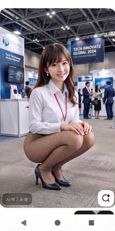 Woman in a white shirt and fishnet stockings squatting in an exhibition hall