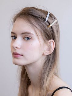 Young woman with blonde hair and blue eyes wearing hair clips