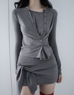 Woman in a gray top and mini skirt with red thigh highs
