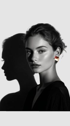 Black and white portrait of a woman with a red earring and dramatic shadow
