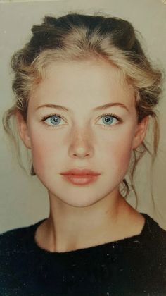 Young woman with blue eyes and freckles in a close-up portrait