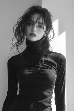 Woman with messy long hair wearing a black turtleneck in a black and white portrait