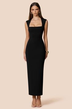 Woman in a black dress with a square neckline and long hair