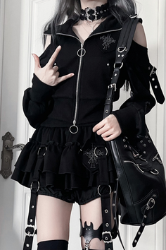 Person in gothic-style black clothing with a choker and shoulder bag