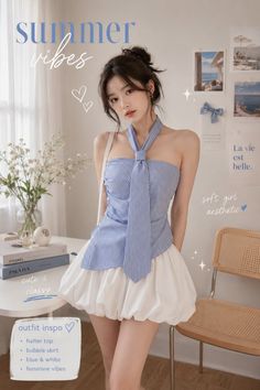 Woman in a blue striped halter top and white bubble skirt indoors