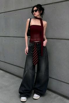 Woman in a strapless top and wide leg jeans with a tie as a belt