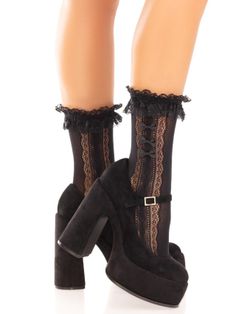 Legs wearing black lace socks with ruffles and platform heels