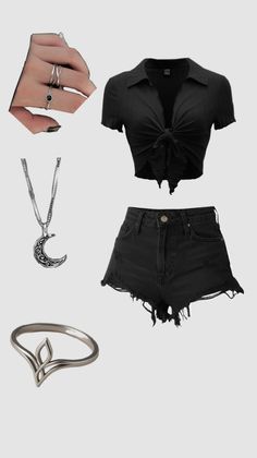 A flat lay of a black crop top, ripped denim shorts, and silver jewelry