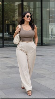 Woman in a ribbed tank top and wide leg pants walking outdoors