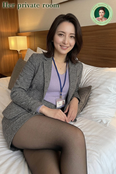 Woman in a suit jacket and mini skirt with black pantyhose sitting on a bed