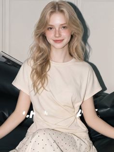 Young woman with blonde hair and freckles wearing a t-shirt and polka dot pants
