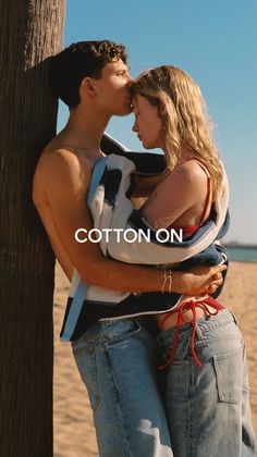 Couple embracing on a beach, man kissing woman's forehead