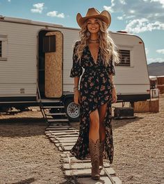 Woman in a cowboy hat and floral dress walking outdoors