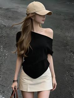 Woman in a black off-shoulder top and mini skirt with a baseball cap